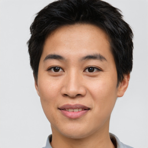 Joyful asian young-adult male with short  brown hair and brown eyes