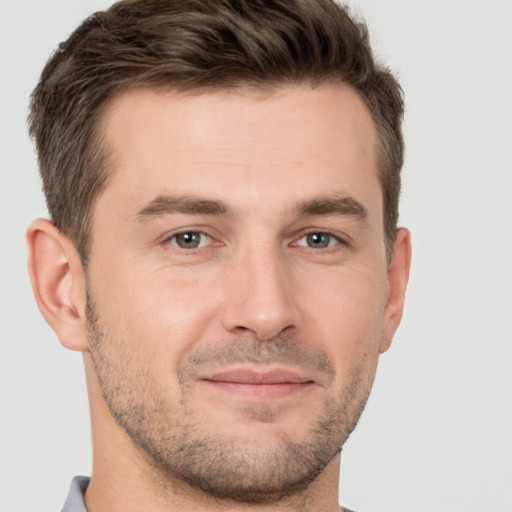 Joyful white young-adult male with short  brown hair and brown eyes