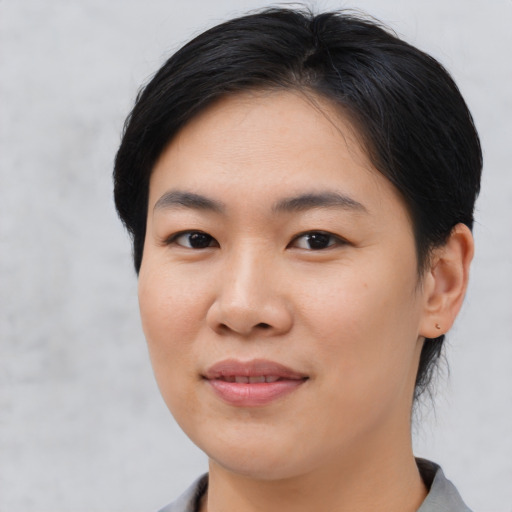 Joyful asian young-adult female with medium  black hair and brown eyes
