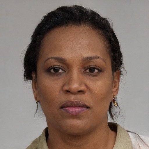 Neutral black adult female with medium  brown hair and brown eyes