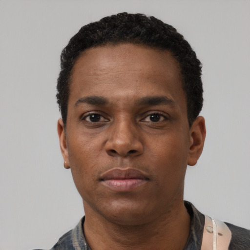 Neutral black adult male with short  black hair and brown eyes