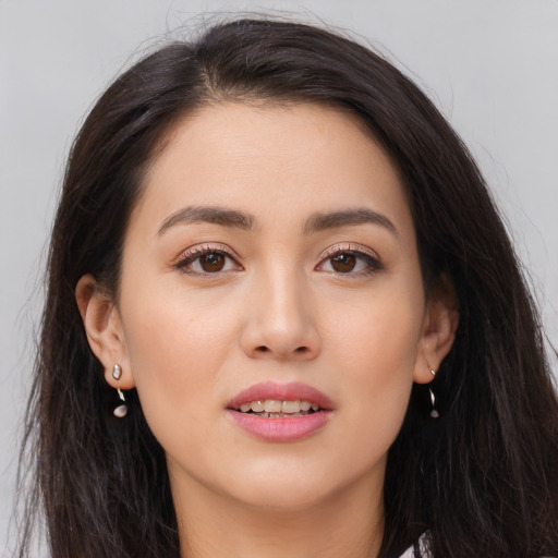 Joyful white young-adult female with long  brown hair and brown eyes