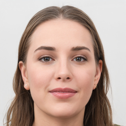 Joyful white young-adult female with long  brown hair and grey eyes