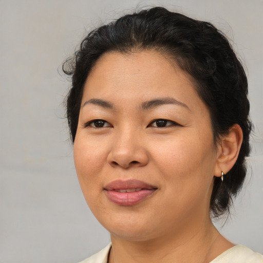 Joyful asian adult female with medium  brown hair and brown eyes