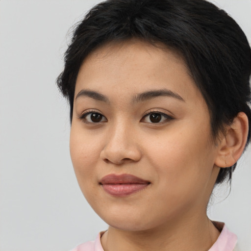 Joyful asian young-adult female with short  brown hair and brown eyes