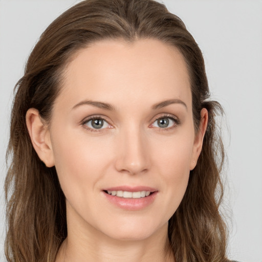 Joyful white young-adult female with long  brown hair and grey eyes