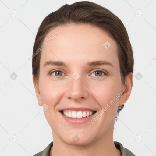 Joyful white young-adult female with short  brown hair and grey eyes