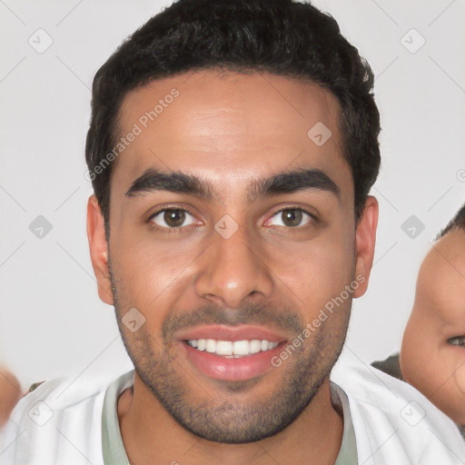 Joyful white young-adult male with short  black hair and brown eyes