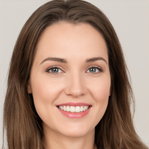 Joyful white young-adult female with long  brown hair and brown eyes