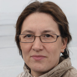 Joyful white adult female with medium  brown hair and grey eyes