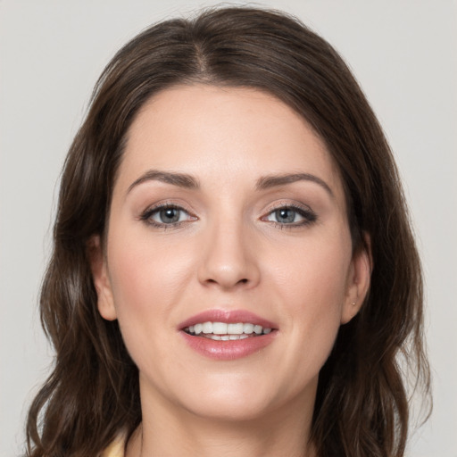 Joyful white young-adult female with medium  brown hair and grey eyes