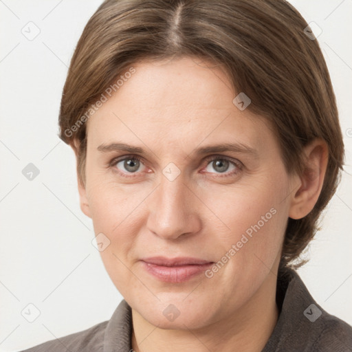 Joyful white young-adult female with short  brown hair and grey eyes