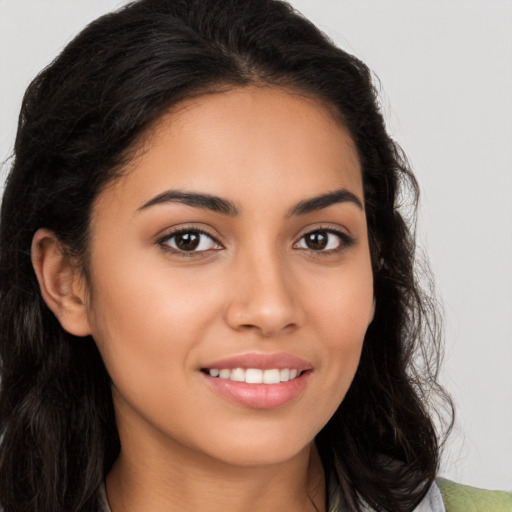 Joyful latino young-adult female with long  brown hair and brown eyes