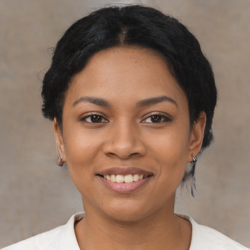 Joyful latino young-adult female with short  black hair and brown eyes