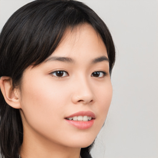 Joyful asian young-adult female with long  brown hair and brown eyes