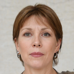 Joyful white adult female with medium  brown hair and grey eyes