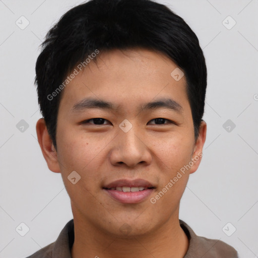 Joyful asian young-adult male with short  black hair and brown eyes