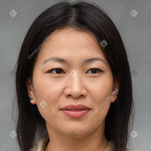 Joyful asian adult female with medium  brown hair and brown eyes