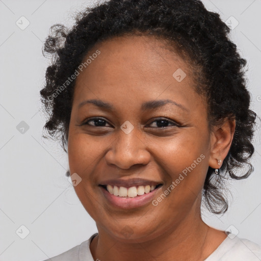 Joyful black young-adult female with medium  brown hair and brown eyes