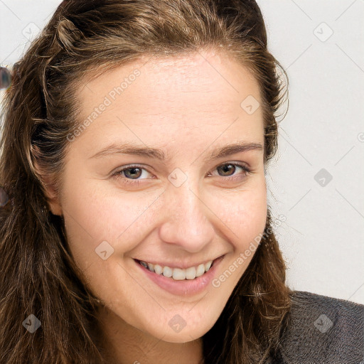 Joyful white young-adult female with long  brown hair and blue eyes