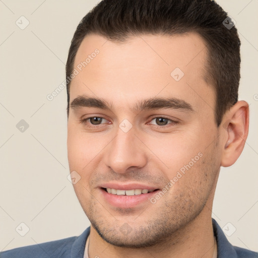 Joyful white young-adult male with short  brown hair and brown eyes