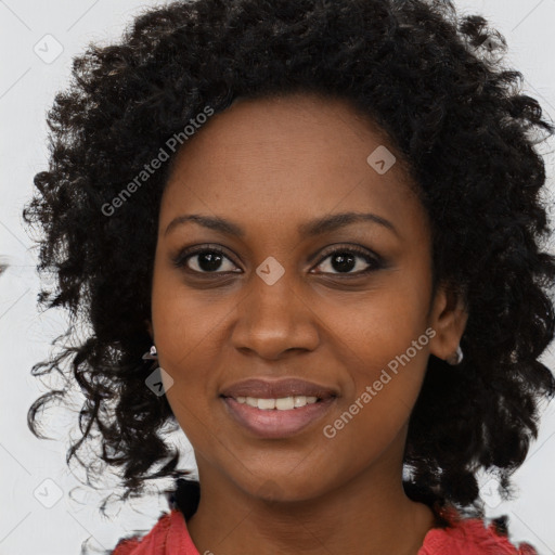 Joyful black young-adult female with long  black hair and brown eyes