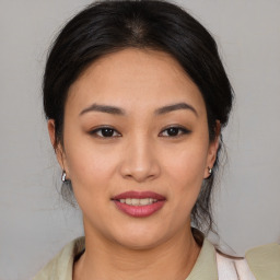 Joyful asian young-adult female with medium  brown hair and brown eyes