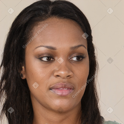 Joyful black young-adult female with long  brown hair and brown eyes