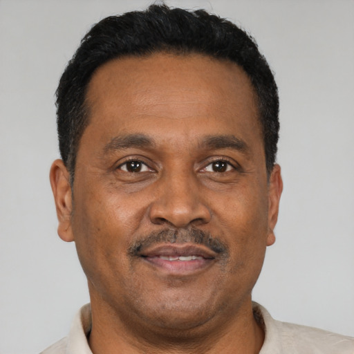 Neutral latino adult male with short  black hair and brown eyes