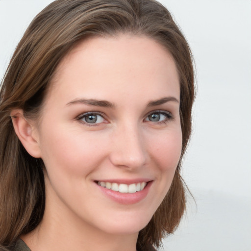 Joyful white young-adult female with long  brown hair and blue eyes