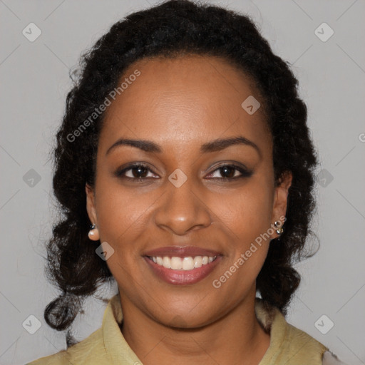 Joyful black young-adult female with long  black hair and brown eyes