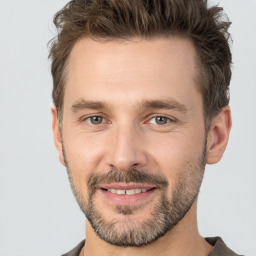 Joyful white adult male with short  brown hair and brown eyes