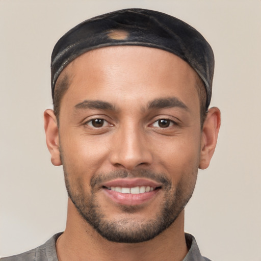 Joyful white young-adult male with short  black hair and brown eyes