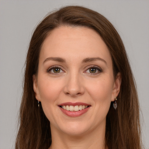 Joyful white young-adult female with long  brown hair and green eyes