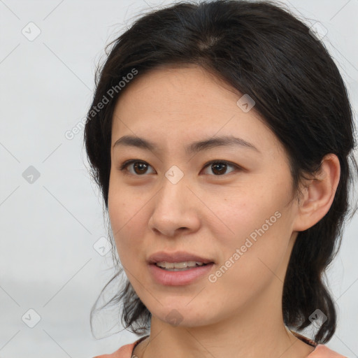 Joyful asian young-adult female with medium  brown hair and brown eyes