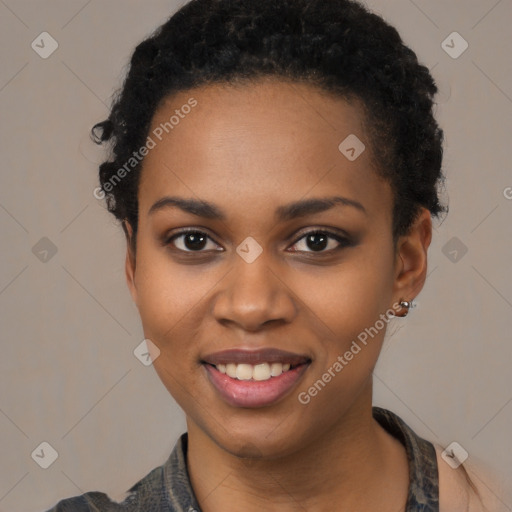 Joyful black young-adult female with short  black hair and brown eyes