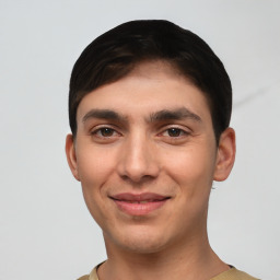 Joyful white young-adult male with short  black hair and brown eyes