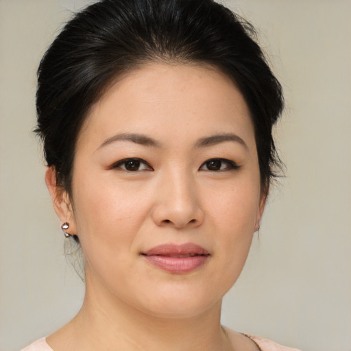 Joyful asian young-adult female with medium  brown hair and brown eyes