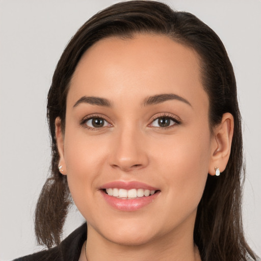 Joyful white young-adult female with long  brown hair and brown eyes