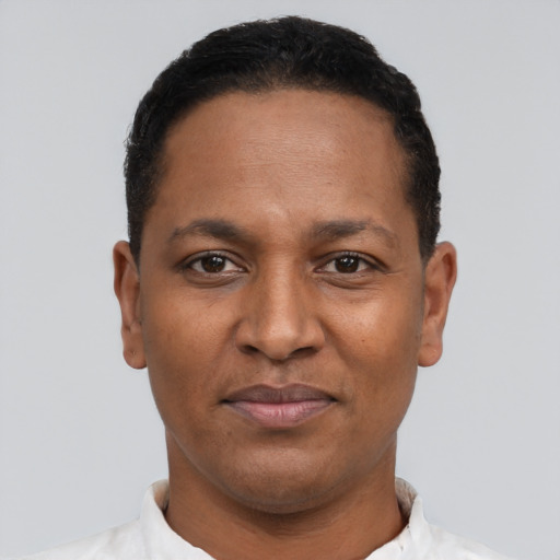 Joyful black adult male with short  black hair and brown eyes