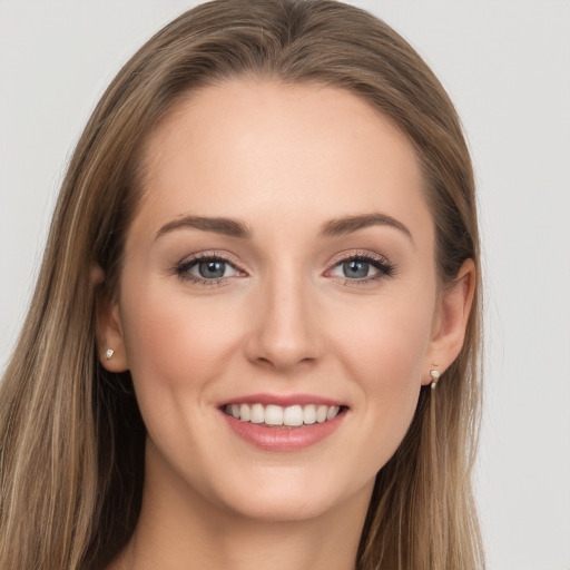 Joyful white young-adult female with long  brown hair and grey eyes