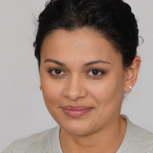 Joyful latino young-adult female with short  brown hair and brown eyes