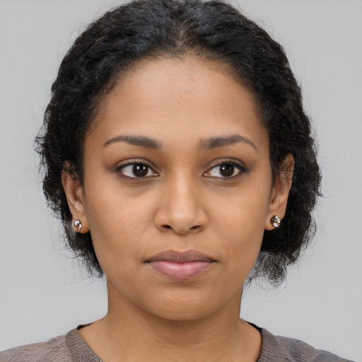 Joyful latino young-adult female with medium  black hair and brown eyes