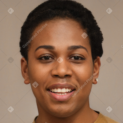 Joyful black young-adult female with short  black hair and brown eyes