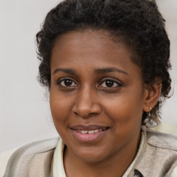 Joyful black young-adult female with medium  brown hair and brown eyes