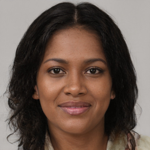 Joyful black young-adult female with medium  brown hair and brown eyes