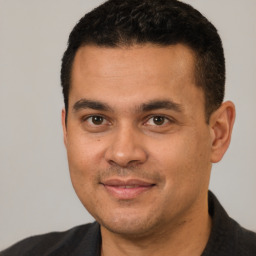 Joyful white young-adult male with short  black hair and brown eyes