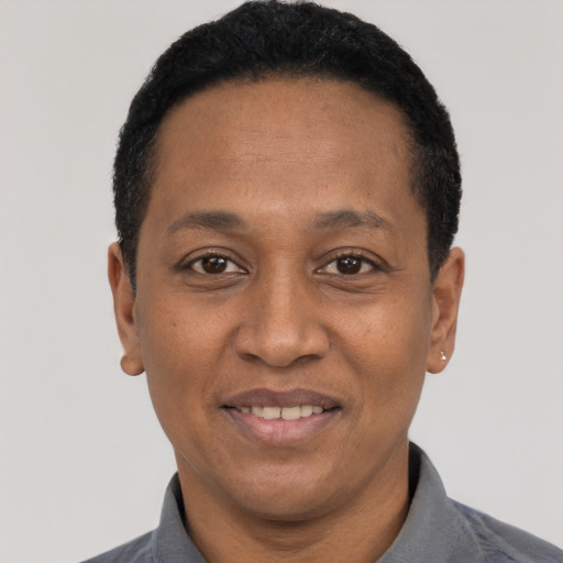 Joyful black adult male with short  black hair and brown eyes