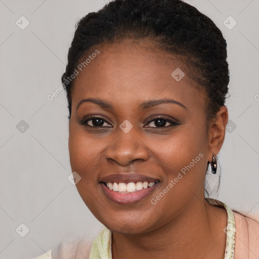 Joyful black young-adult female with short  brown hair and brown eyes