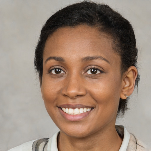 Joyful black young-adult female with medium  brown hair and brown eyes